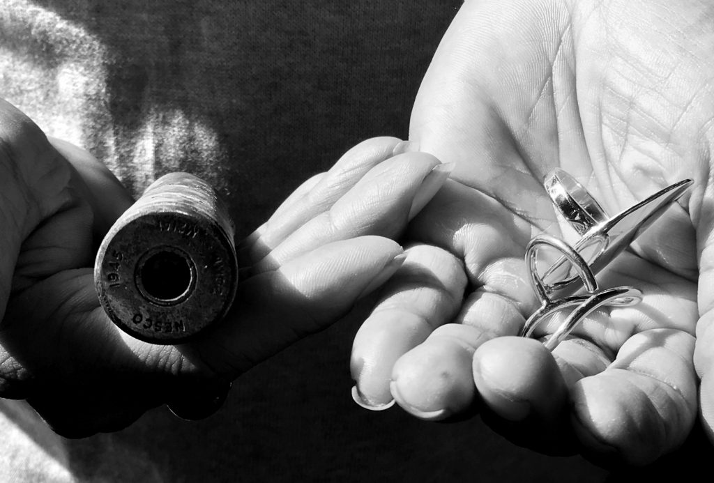 hand holding jewellery and bullet