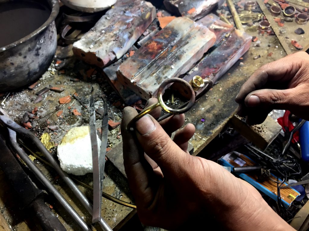 artisan making a bracelet