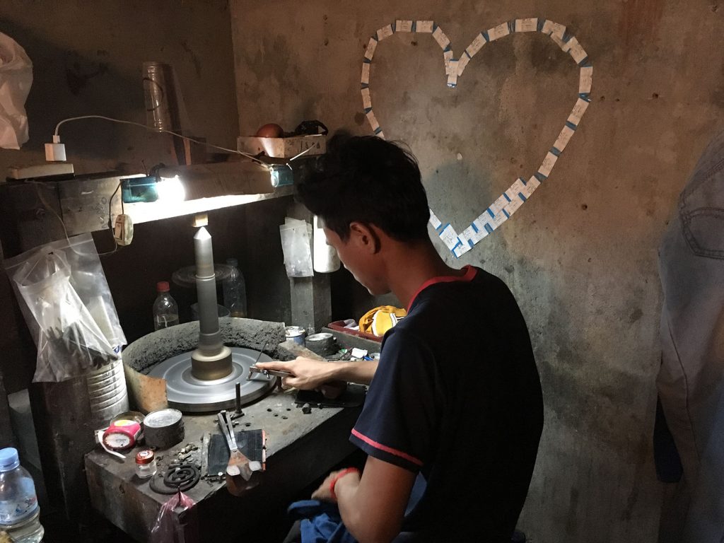 polishing an amethyst gemstone