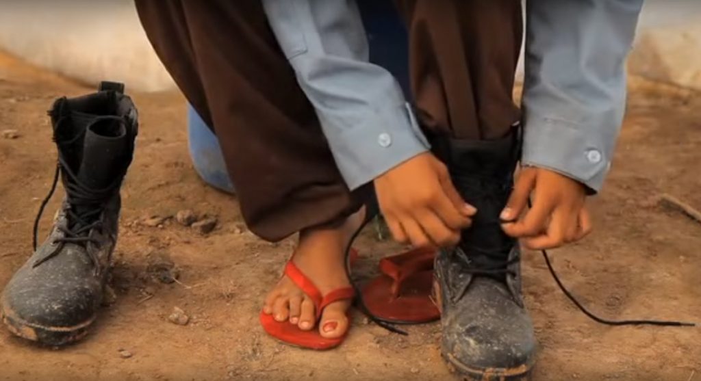 woman landmine clearing officer getting dressed in uniform