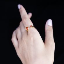 hand with orange stone ring