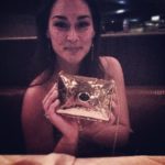 woman holding gold clutch
