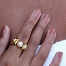 pearl ring on hand.